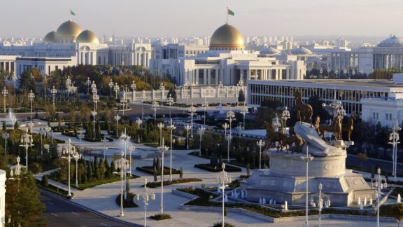 Ashgabat, Turkmenistan's capital, features white marble buildings, golden domes, statues, and green spaces.