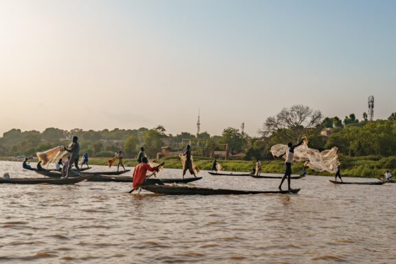 Nigerien fishermen fishing on their boats