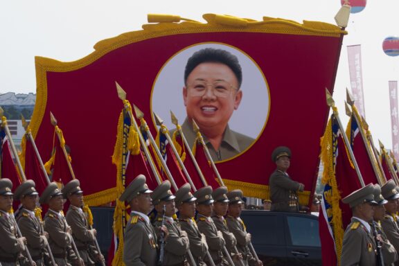 North Korean soldiers at the military parade in Pyongyang with the portrait of Kim Jonhg-Il of the 60th anniversary of the conclusion of the Korean War. Pyongyang, North Korea.