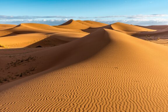 Sand dunes of Erg Chigaga under a clear blue sky.