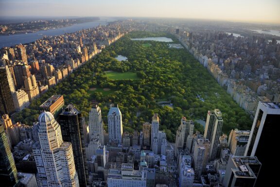 Central Park aerial view, Manhattan, New York; Park is surrounded by skyscraper.