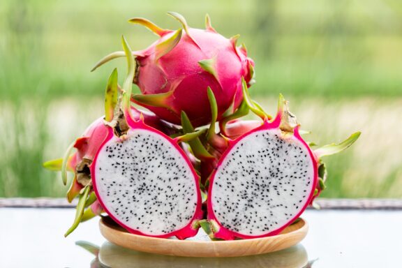 Sliced Dragon Fruit on Plate Tropical fruits healthy dragon fruits on a platter.