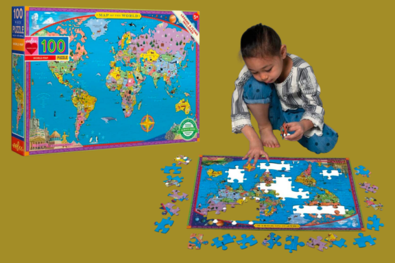 Child Playing with World Map Puzzle Eebo world map 100 piece puzzle