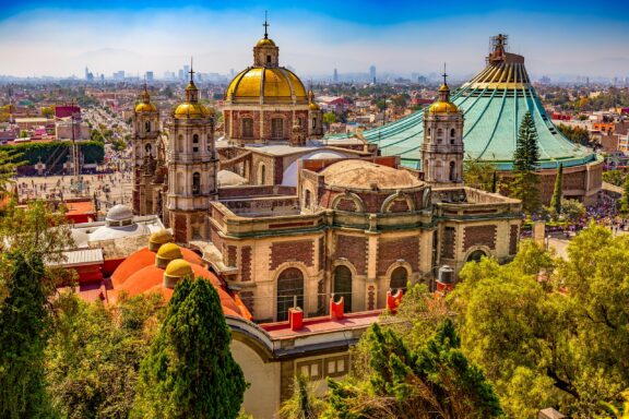 Basilica of Our Lady of Guadalupe. The old and the new basilica, cityscape of Mexico City on the far