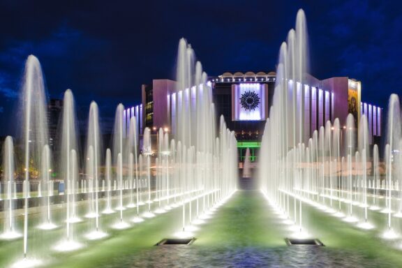 Fountain Lights in Front of Modern Building at Night Fountains in front of the National Palace of Culture