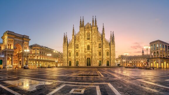 Panoramic view of Piazza del Duomo square with Milan Cathedral, Duomo di Milano, and Galleria Vittorio Emanuele II, Italy, on sunrise. Milan Cathedral is one of the largest churches in the world.