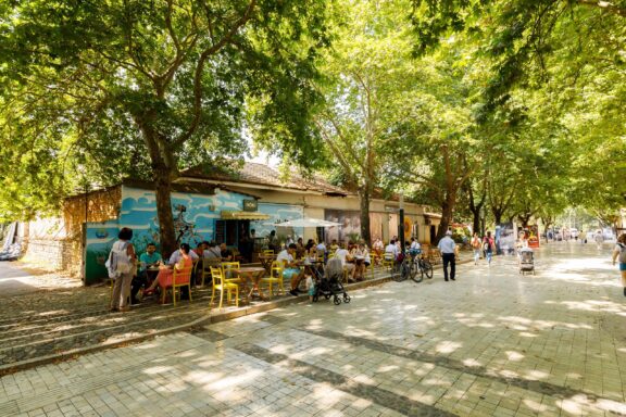 Outdoor Cafe Scene with Locals in Tirana Tirana locals enjoying a stroll and outdoor cafe