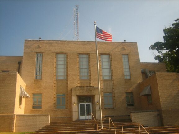 An American flag flies in front of the Lafayette County Courthouse in Lewisville, Arkansas.