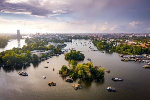 Aerial view of Spree River in front of the panoramic cityscape of Berlin