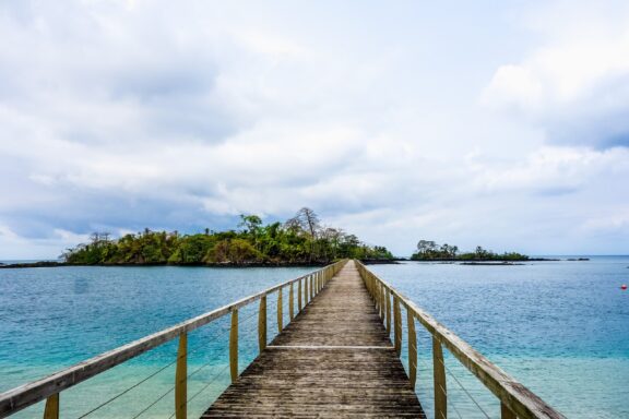 Wooden Pier Leading to Tropical Island Resort Wooden bridge on the beach near Sipopo Luxury Resort in Malabo