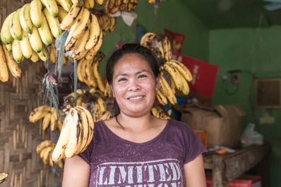 A local vendor posing with her fruits inside her store in the Philippines.