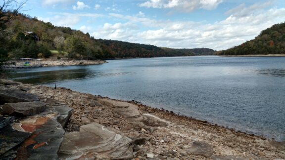 Serene View of Beaver Lake, Arkansas with Rocky Shoreline and Forested Hills The shoreline of Beaver Lake near Springdale, Arkansas.