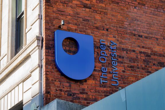 A sign for the Open University hangs on a building in Belfast, Northern Ireland.