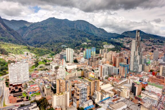Aerial View of Bogotá Cityscape with Mountains in the Background Aerial view of Bogota on a cloudy day