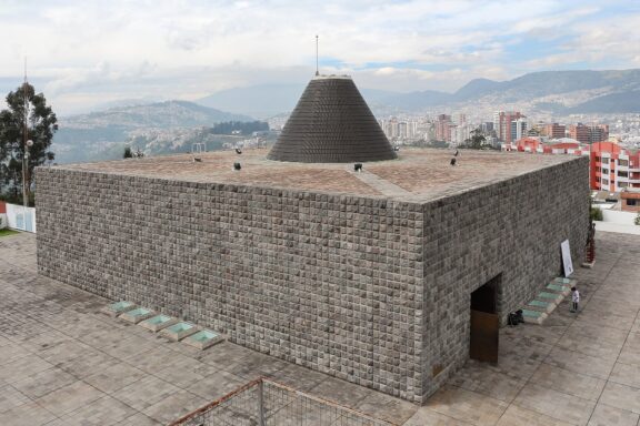 Stone Building with Pyramid Roof Overlooking City Capilla del Hombre museum in Quito