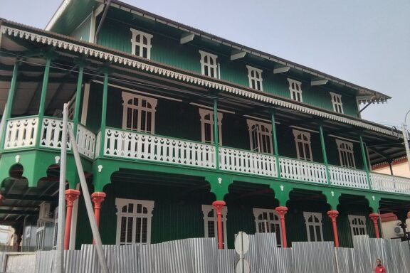 Green Colonial House with Balconies and Red Pillars Casa Verde in Malabo
