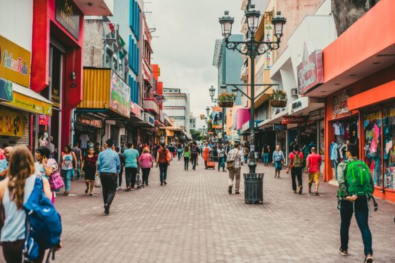 Bustling Street Scene with Pedestrians and Colorful Shops People walking on the central avenue in San José, Costa Rica