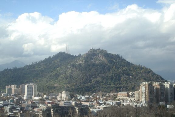 Hilltop Overlooking Cityscape Distant view of Cerro San Cristobal hill in Santiago
