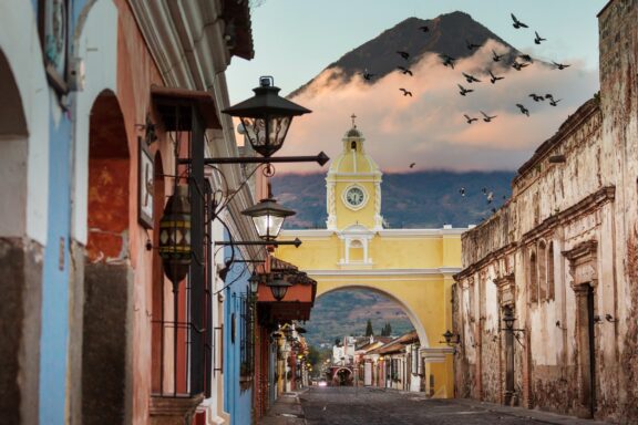 Colonial Architecture and Arched Gateway with Volcano in the Background Streets of Antigua, renowned for its Spanish colonial architecture