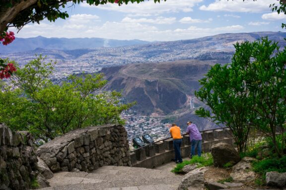Two People Overlooking a Valley from a Mountain Observatory Observation point from Cristo del Picacho, Tegucigalpa