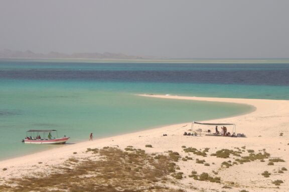 Tropical Beach with Boat and Visitors in Dahlak, Eritrea Dahlak archipelago near Massawa