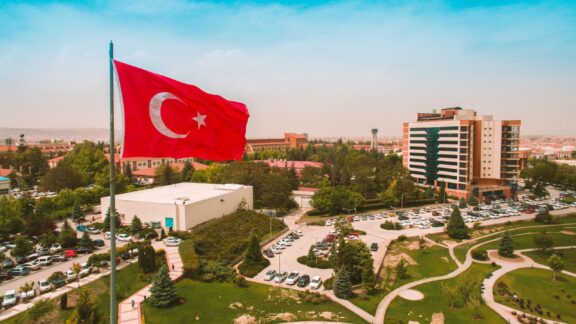 A Turkish flag flies above an Anadolu University campus park in Eskişehir, Turkey. 