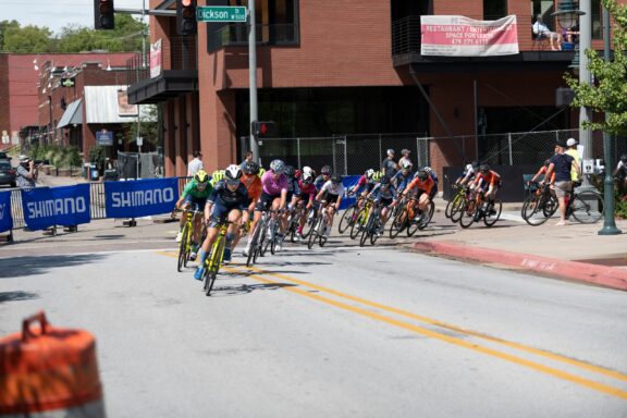 Cyclists round a corner in Fayetteville, Arkansas during the annual Joe Martin Stage Race.