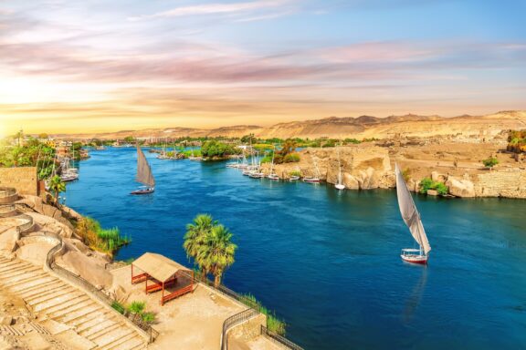 Feluccas Sailing on the Nile River at Sunset Traditional Feluccas in the Nile River