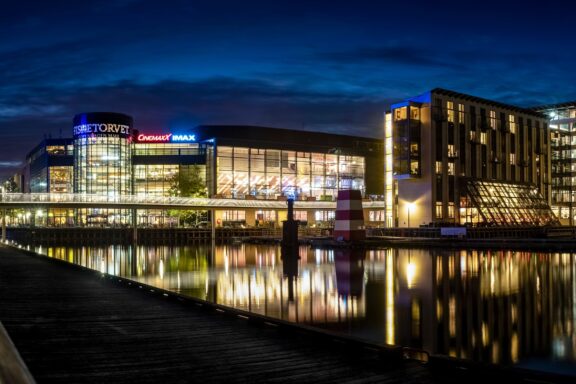 Nighttime View of Waterfront Building with Reflections Fisketorvet near the Kalvebod Brygge waterfront in Copenhagen at night