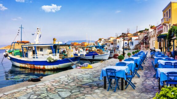 Boats Docked at a Quaint Greek Seaside Town traditional Greece series - Chalki island with old boats and tavernas