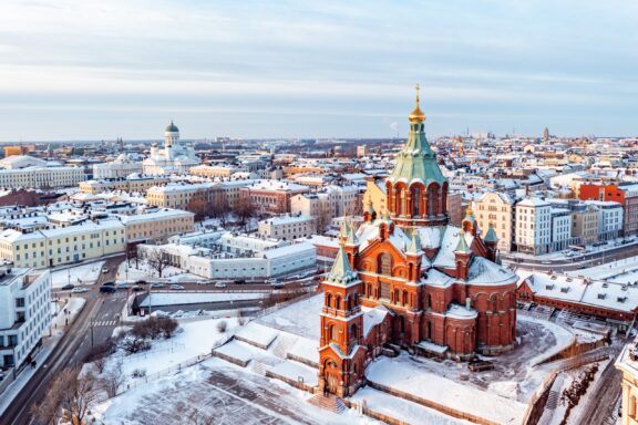 Beautiful aerial view of Helsinki city covered in snow and showing the famous Uspenski Cathedral.