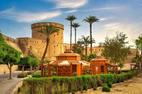 Ancient Cairo Citadel with Palm Trees Ancient cairo citadel at beautiful summer sunrise