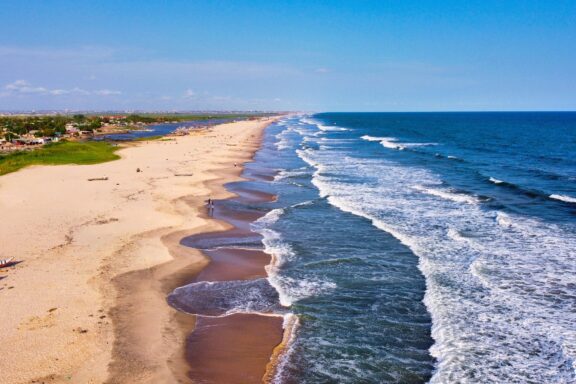 Aerial View of a Sandy Beach with Waves Crashing okrobite Beach, 20 km west of Accra