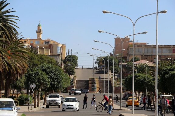 City Street Scene with Pedestrians and Vehicles Locals strolling near Mai Jah Jah in Asmar
