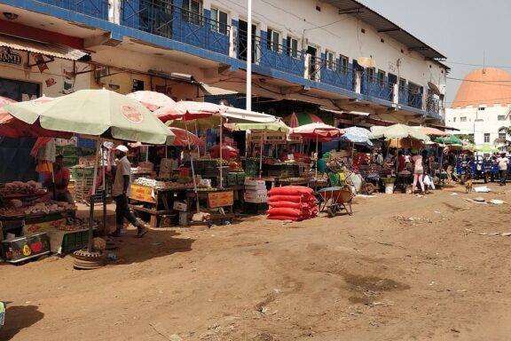 Street Market with Colorful Umbrellas and Vendors Mercado Central de Bissau