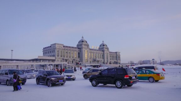 Mohe in China showing a car parking lot and building during winter.