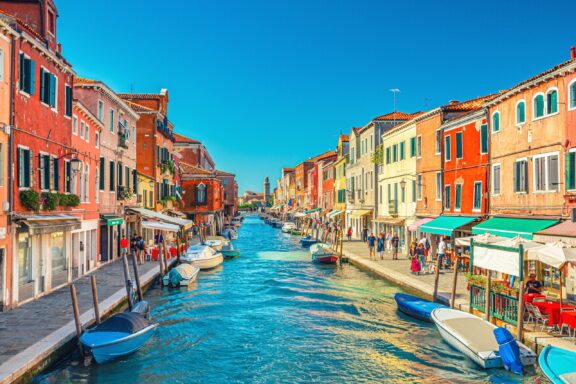 Colorful buildings line a canal in Murano, Italy.