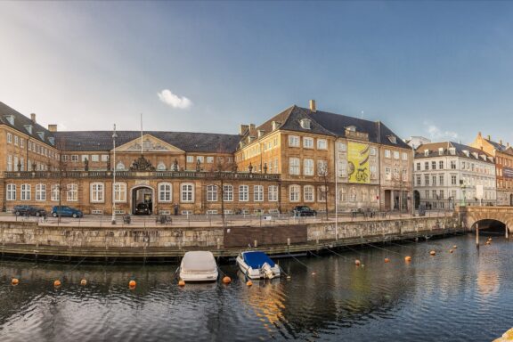 Sunset View of the National Museum of Denmark by the Canal National Museum of Denmark in Copenhagen
