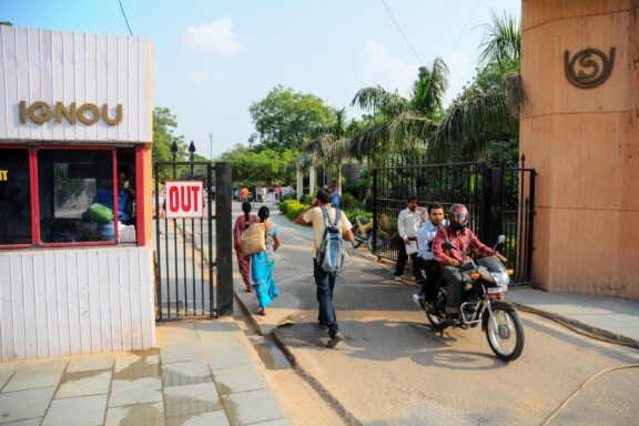 People pass through a gate of the IGNOU campus in New Dehli, India.