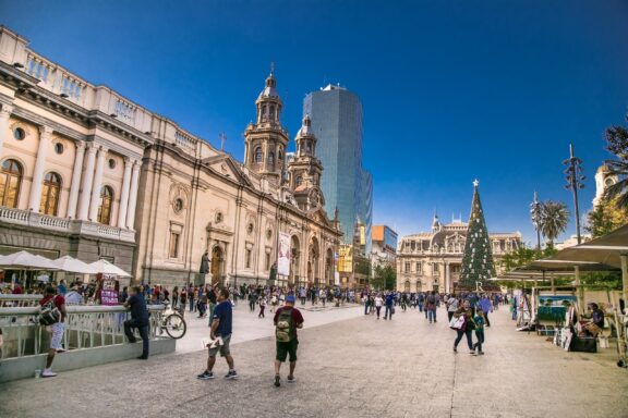 People commute in the Plaza de Armas square in Santiago