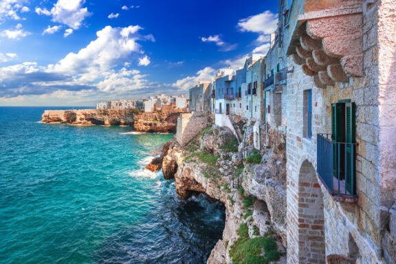 Buildings line a dramatic coastline in the village of Polignano a Mare.