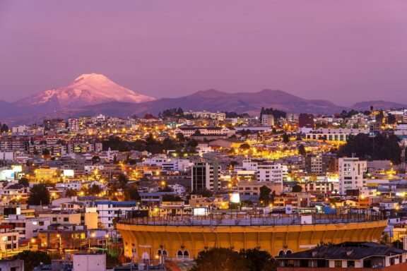 Aerial View of Quito at Dusk with Mountain in Background Modern district in Quito at dusk