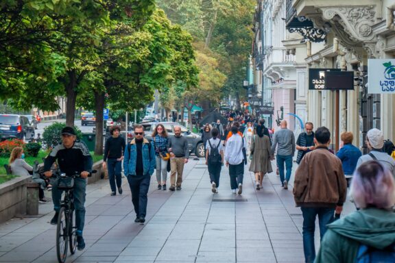Crowded City Street with Pedestrians and Cyclist Tbilisi locals commute on Rustaveli Avenue