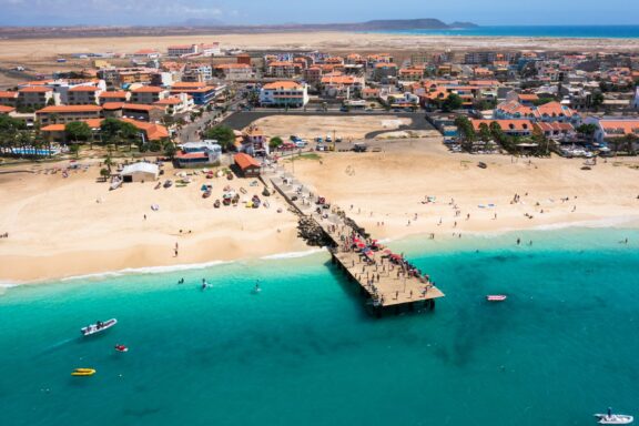 Aerial View of Coastal Town with Pier on Sal Island, Cape Verde Aerial view of Santa Maria beach pontoon in Sal Island Cape Verde - Cabo Verde.