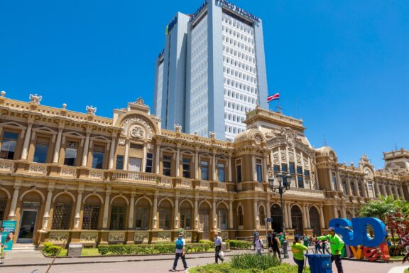Exterior View of San Jose Post Office with People and Modern Skyscraper in the Background San José post office in front of the Banco Nacional de Costa Rica