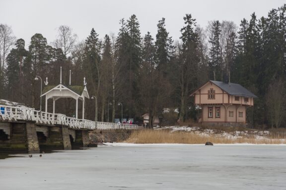 Winter View of Seurasaari Bridge and House in Helsinki Wooden bridge and an old house in Seurasaari, elements of the Open-Air Museum