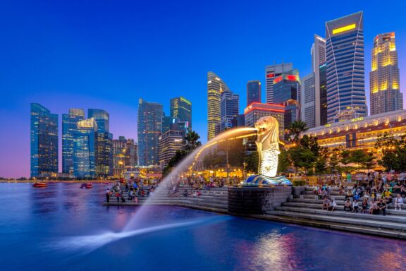 The Merlion sculpture shoots water into the bay at Merlion Park in Singapore. 