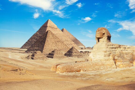 Sphinx and Pyramids of Giza under Blue Sky Egypt cairo giza general view of pyramids with sphinx