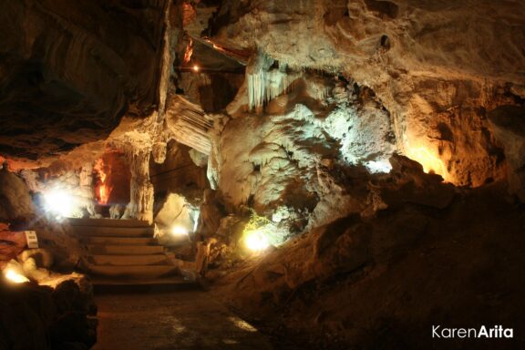 Illuminated Cave Interior with Staircase The Taulabé Caves, believed to be used by indigenous people from pre-Colombian era