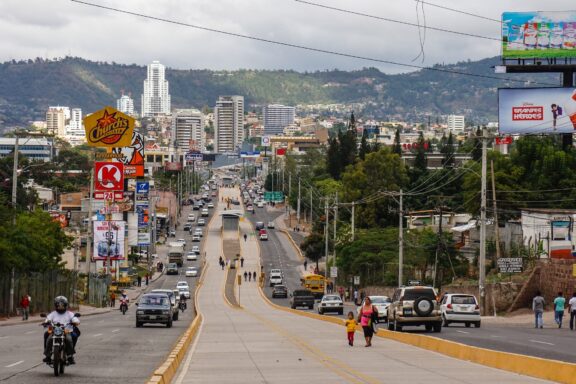 Street Scene in Tegucigalpa with Locals and Traffic Tegucigalpa locals commute a bustling street